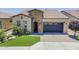 Beautiful home featuring brick accents, manicured lawn, paved driveway, and ample curb appeal at 841 E Farmers Ln, Queen Creek, AZ 85140