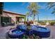 Beautifully designed fountain with blue tile, potted flowers, and outdoor seating area with views at 841 E Farmers Ln, Queen Creek, AZ 85140