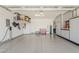 Spacious garage with epoxy flooring, overhead storage racks, ample cabinet space, and an electric vehicle charger at 841 E Farmers Ln, Queen Creek, AZ 85140