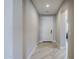 Bright hallway with light wood-look tile flooring leading to the front door and living spaces at 841 E Farmers Ln, Queen Creek, AZ 85140