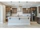 Stylish kitchen featuring wood cabinets, a large island, stainless steel appliances, and modern pendant lights at 841 E Farmers Ln, Queen Creek, AZ 85140