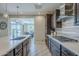 Modern kitchen featuring sleek countertops, stainless steel appliances, tile backsplash, and an open layout at 841 E Farmers Ln, Queen Creek, AZ 85140