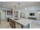 Bright kitchen featuring a central island, modern lighting, stainless steel appliances, and open-concept layout at 841 E Farmers Ln, Queen Creek, AZ 85140