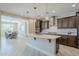Stylish kitchen boasts a large island, pendant lighting, stainless steel appliances, and an open-concept design at 841 E Farmers Ln, Queen Creek, AZ 85140