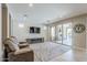 Spacious living room with a stone accent wall, comfortable seating, and sliding glass doors to the outdoor area at 841 E Farmers Ln, Queen Creek, AZ 85140
