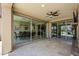 Covered patio features travertine tile flooring, a ceiling fan, and expansive sliding glass doors at 841 E Farmers Ln, Queen Creek, AZ 85140