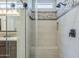 Glass shower with pebble tile flooring and a built-in bench at 841 E Farmers Ln, Queen Creek, AZ 85140
