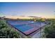 Multiple outdoor tennis courts with lush landscaping at sunset at 841 E Farmers Ln, Queen Creek, AZ 85140