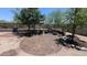 Backyard showcases a brick patio, perfect for outdoor gatherings, and gravel, enclosed by a wrought iron fence at 8419 S 40Th Dr, Laveen, AZ 85339