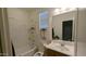 Clean bathroom features a shower-tub combo, wood vanity and tile flooring at 8419 S 40Th Dr, Laveen, AZ 85339