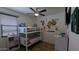 Bright bedroom features a bunk bed, natural light and a decorative accent wall at 8419 S 40Th Dr, Laveen, AZ 85339