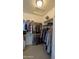 Spacious walk-in closet featuring ample shelving, closet rods, and a skylight for natural light at 8419 S 40Th Dr, Laveen, AZ 85339