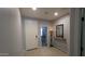 Inviting entryway with a white front door, neutral walls, light tile flooring, and a decorative mirror at 8419 S 40Th Dr, Laveen, AZ 85339