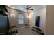 Exercise room with ceiling fan, a large window, rubber flooring and wall-mounted equipment at 8419 S 40Th Dr, Laveen, AZ 85339