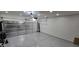 A clean, well-lit garage features epoxy flooring and an insulated garage door at 8419 S 40Th Dr, Laveen, AZ 85339