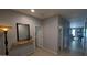 Hallway with neutral walls, decorative mirror and accessories, and light tile flooring at 8419 S 40Th Dr, Laveen, AZ 85339