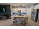 Features a spacious island with granite countertops, barstool seating, stainless steel appliances, and modern finishes at 8419 S 40Th Dr, Laveen, AZ 85339