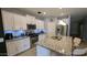 Bright, modern kitchen with white cabinetry, stainless steel appliances, granite countertops, and stylish pendant lighting at 8419 S 40Th Dr, Laveen, AZ 85339