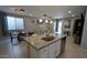 Modern kitchen boasts a large island with granite countertops, stainless steel appliances, and an open concept layout at 8419 S 40Th Dr, Laveen, AZ 85339