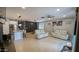 An open living area with neutral walls, tile flooring, ample lighting, and stylish, comfortable seating at 8419 S 40Th Dr, Laveen, AZ 85339