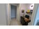 Compact home office with desk, chair, and shelving within a neutral-toned room with tile flooring at 8419 S 40Th Dr, Laveen, AZ 85339