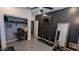 Home office setup with a dark accent wall, a built-in closet, and an exercise bench at 8419 S 40Th Dr, Laveen, AZ 85339