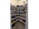 Organized pantry with multiple shelves, offering ample storage for food and kitchen essentials at 8419 S 40Th Dr, Laveen, AZ 85339