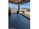 Covered patio overlooking a backyard, complete with an area of artificial turf and playground at 8419 S 40Th Dr, Laveen, AZ 85339