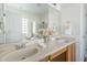 Well-lit bathroom featuring double sinks, decorative accents, and a glass-enclosed shower at 8438 W Bajada Rd, Peoria, AZ 85383