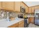 Close up of a modern kitchen with stainless steel appliances and tile backsplash at 8438 W Bajada Rd, Peoria, AZ 85383