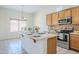 Well-lit kitchen features stainless steel appliances and a central island with seating at 8438 W Bajada Rd, Peoria, AZ 85383