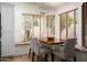 Bright breakfast nook featuring a wooden table, comfortable seating, and serene backyard views through window blinds at 8896 E Mescal St, Scottsdale, AZ 85260