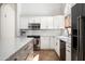 Modern kitchen with white cabinetry, stainless steel appliances, a center island and neutral countertops at 8896 E Mescal St, Scottsdale, AZ 85260