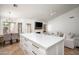 Open-concept kitchen, dining, and living area with a spacious island, fireplace, and comfortable seating at 8896 E Mescal St, Scottsdale, AZ 85260