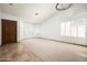 Spacious living room with large windows and neutral carpet and tile flooring at 8896 E Mescal St, Scottsdale, AZ 85260
