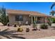 Inviting single-story home showcasing desert landscaping, cacti, and a cozy front patio seating area to enjoy the Arizona sunshine at 932 Leisure World --, Mesa, AZ 85206