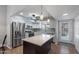 This well-lit kitchen features stainless steel appliances, white cabinets, a central island, and a modern design at 932 Leisure World --, Mesa, AZ 85206