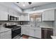 Modern kitchen featuring stainless steel appliances, sleek white cabinetry, granite countertops, and new range oven at 932 Leisure World --, Mesa, AZ 85206
