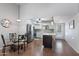 Bright kitchen boasts stainless steel appliances, white cabinets, a center island, and is open to the dining and living areas at 932 Leisure World --, Mesa, AZ 85206