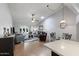 Spacious living room with high ceilings, modern furnishings, a dining area, and seamless flow to the outdoor patio through glass doors at 932 Leisure World --, Mesa, AZ 85206