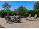 Outdoor patio featuring brick and crushed stone with comfortable lounge chairs and outdoor dining table at 932 Leisure World --, Mesa, AZ 85206