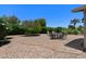 Landscaped backyard with an outdoor patio area featuring a table with chairs, plus lounge chairs at 932 Leisure World --, Mesa, AZ 85206