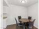 Cozy dining area features a round wood table and four comfortable chairs, ideal for intimate meals at 948 S Alma School Rd # 97, Mesa, AZ 85210