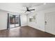 Bright living room showcasing wood floors, ceiling fan, and sliding glass door to the patio at 948 S Alma School Rd # 97, Mesa, AZ 85210