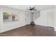 Bright living room with wood flooring, a ceiling fan, a staircase, and a front door at 948 S Alma School Rd # 97, Mesa, AZ 85210