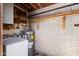 Utility room with water heater and laundry machine with exposed brickwork at 948 S Alma School Rd # 97, Mesa, AZ 85210