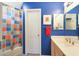 Stylish bathroom with blue walls, vanity, and tiled shower/tub at 9932 N 16Th E Pl, Phoenix, AZ 85020