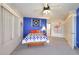 Cozy bedroom featuring a ceiling fan, window, and comfortable bed at 9932 N 16Th E Pl, Phoenix, AZ 85020