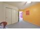 Spare bedroom featuring a yellow accent wall, doorway, closet, and ceiling fan at 9932 N 16Th E Pl, Phoenix, AZ 85020