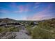 Expansive sunset city view showcasing the neighborhood, landscape, and mountain backdrop offering a sense of location at 9932 N 16Th E Pl, Phoenix, AZ 85020